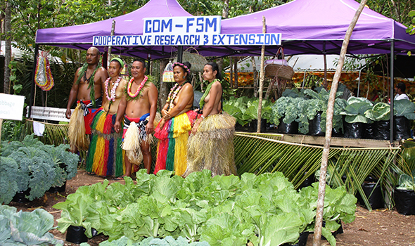 CRE staff pose in front of the booth 590-350